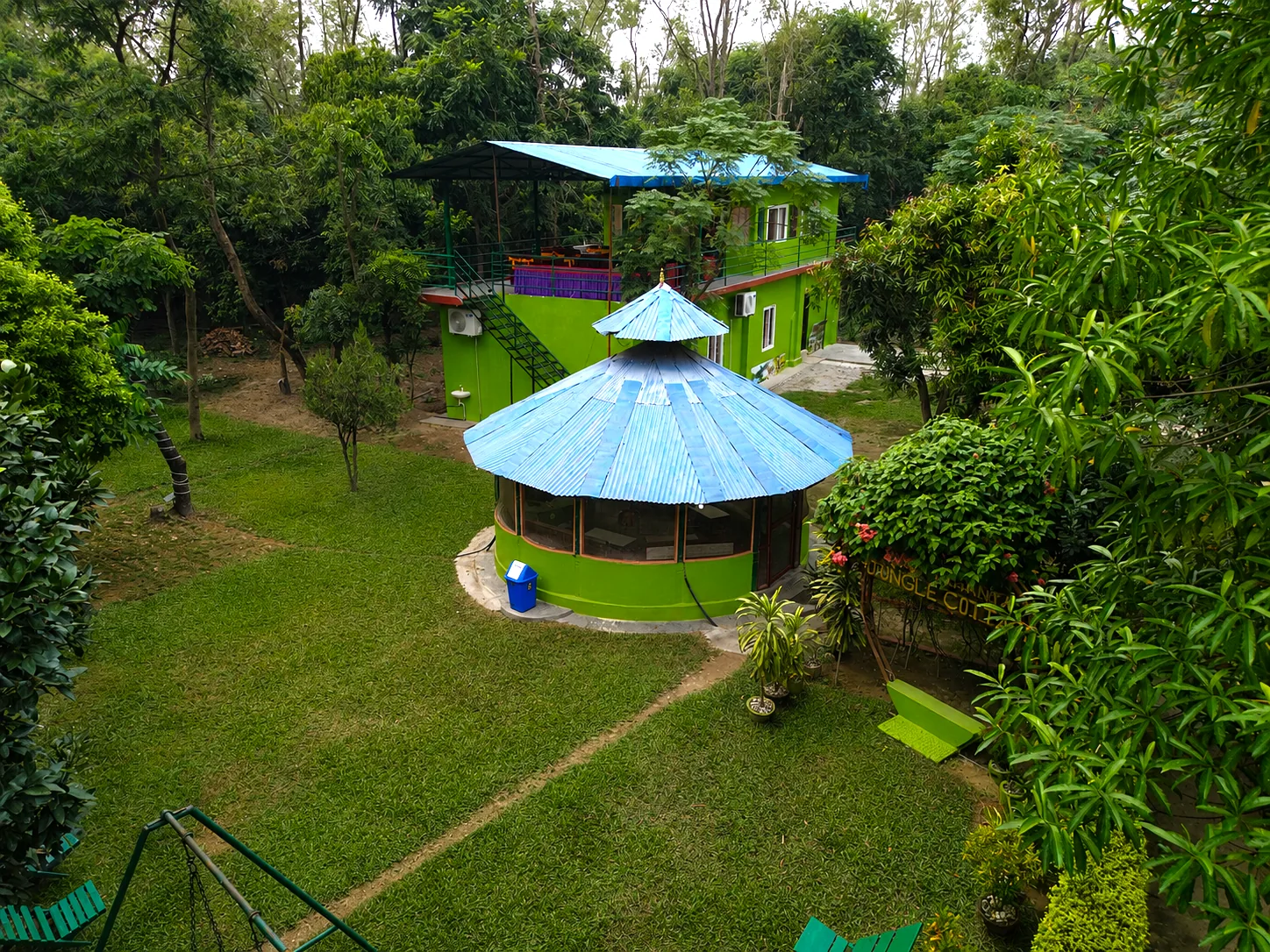 Aerial view of Shuklaphanta Jungle Cottage — round restaurant and green cottage blocks set in jungle gardens