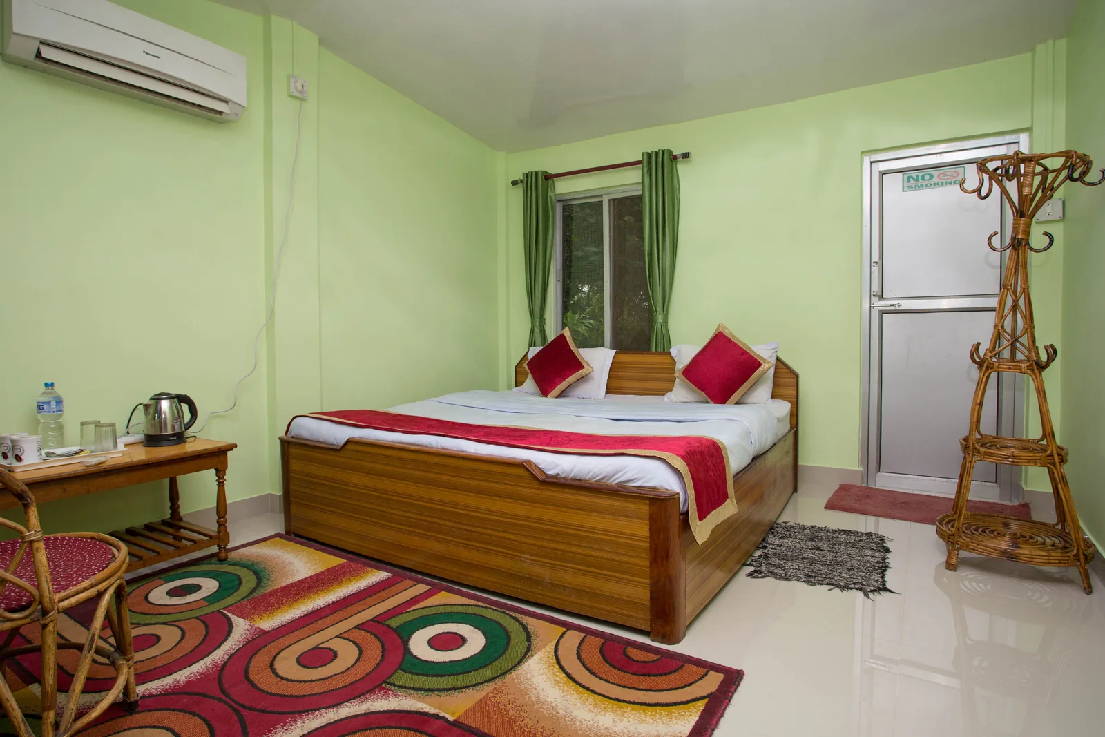 Master Bed Room at Shuklaphanta Jungle Cottage — double bed, air conditioning and writing desk