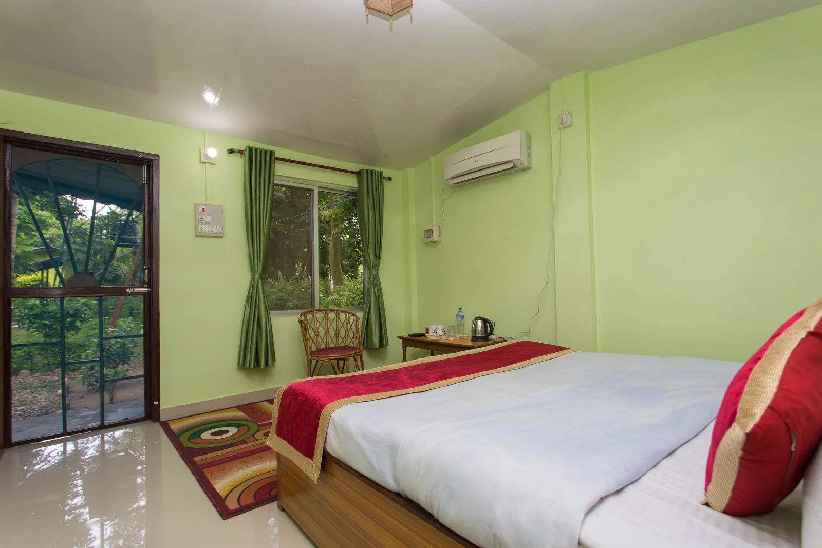 Master Bed Room — double bed with private garden door and jungle-facing window