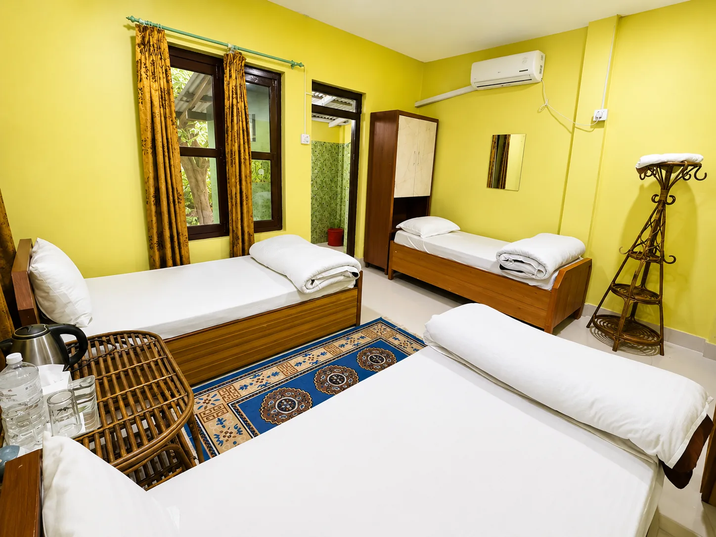 Triple Bed Room at Shuklaphanta Jungle Cottage — three beds, ideal for families