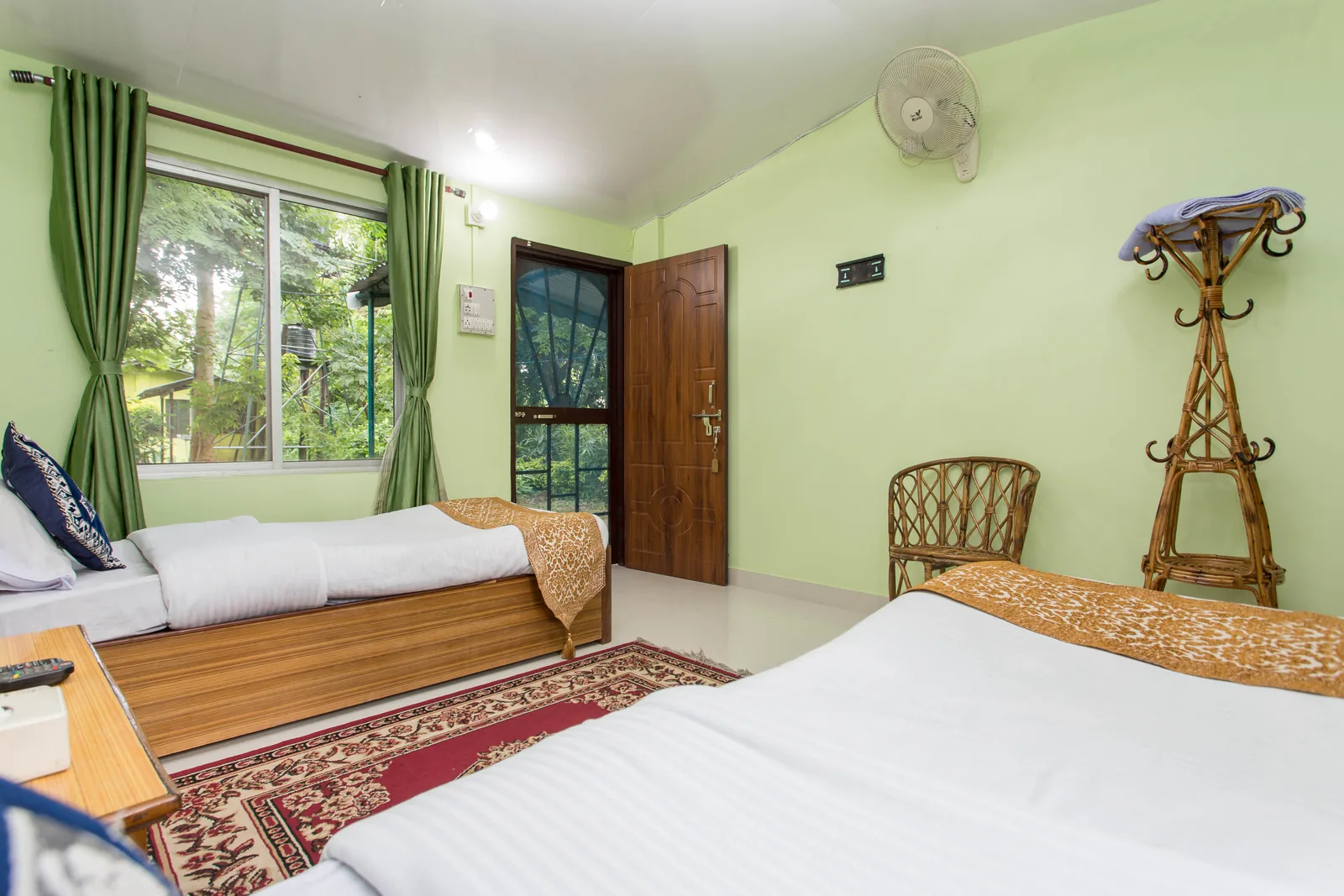 Twin Single Room — beds with garden-facing window and jungle view